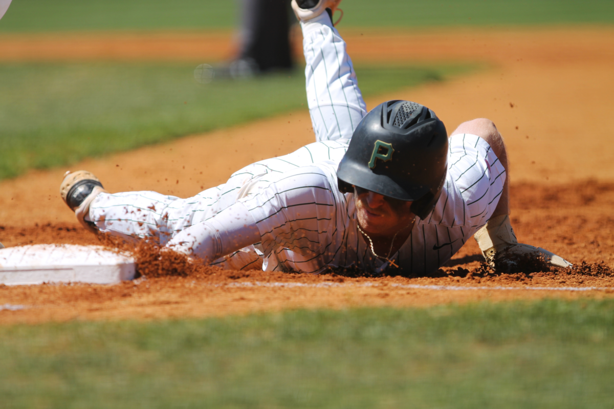 Senior Trace Cates slides back into first place. He and the baseball team will compete over Spring Break.